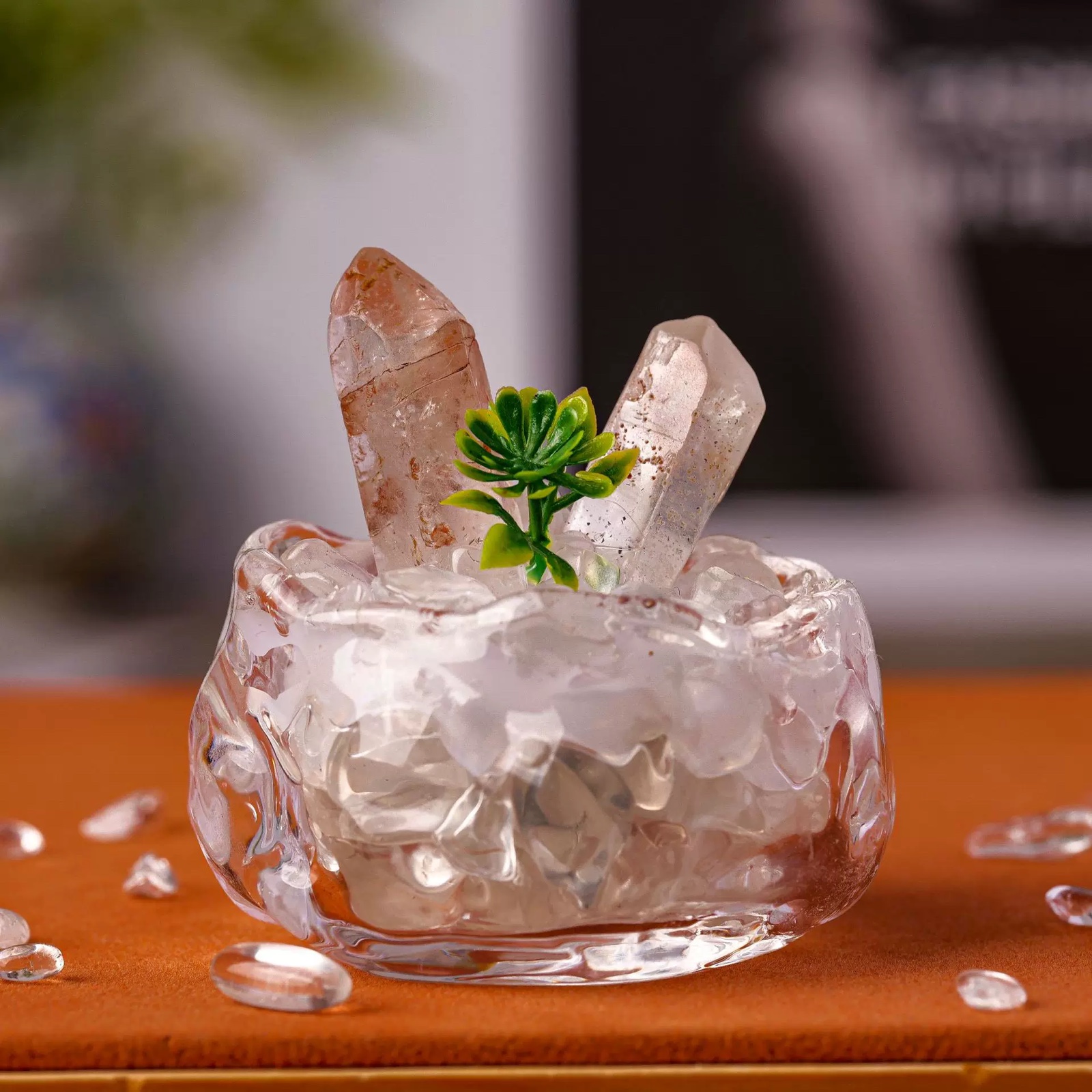 Close-up of clear quartz points and crystal chips in a clear bowl